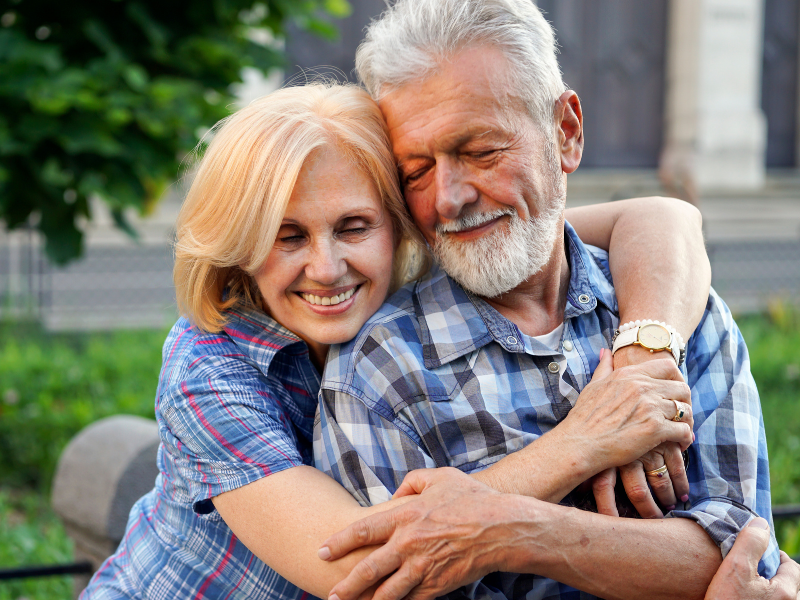 Happy senior couple embracing outdoors
